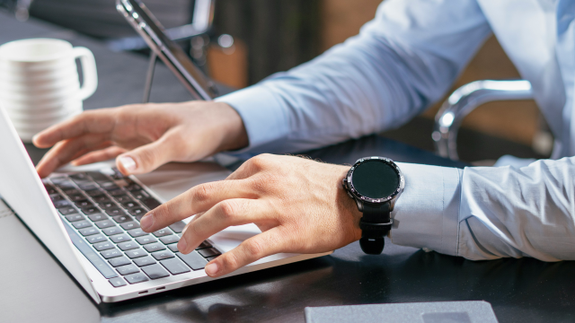 Financial advisor typing on a laptop